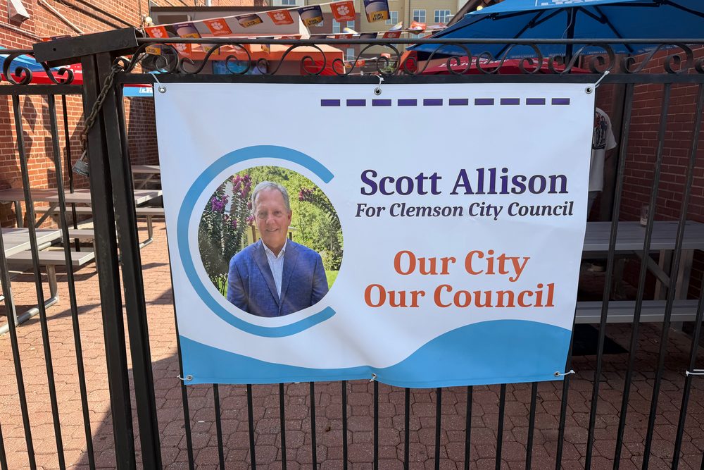 A Scott Allison for Clemson City Council banner hanging on the patio railing at TTT