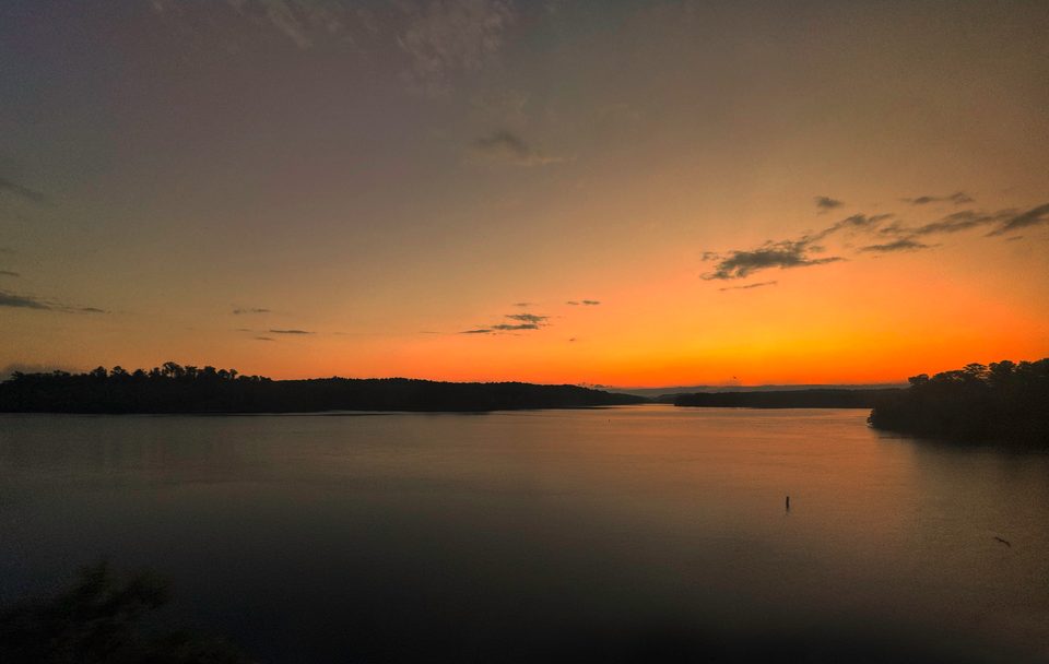 Lake Hartwell in Clemson, South Carolina, under an orange sky.
